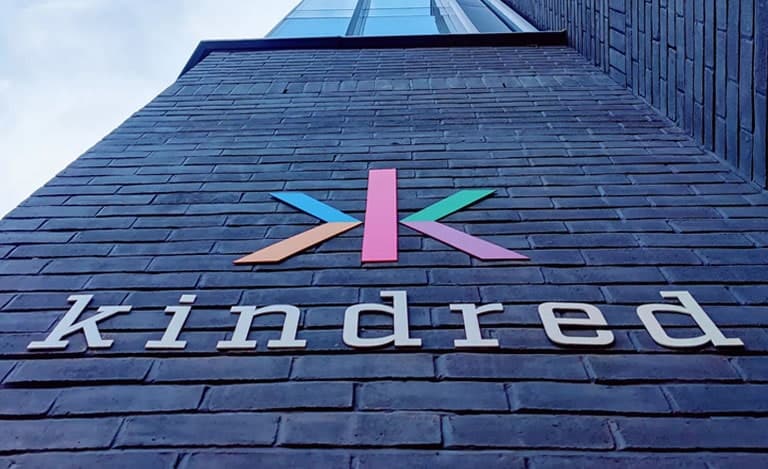 Kindred Group's logo on the wall of the building
