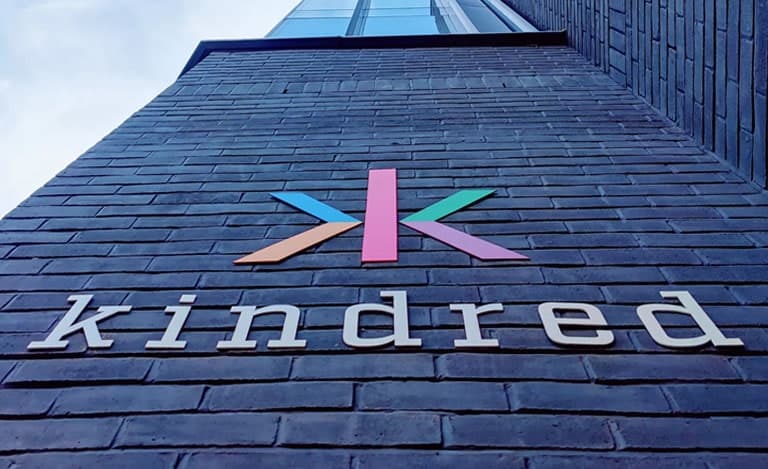 Kindred Group's logo on the wall of the building